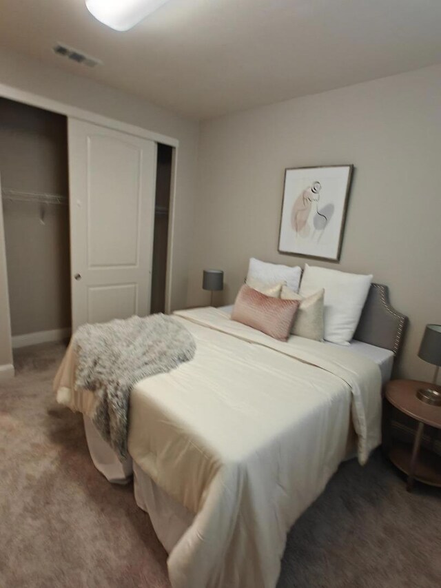 carpeted bedroom featuring a closet