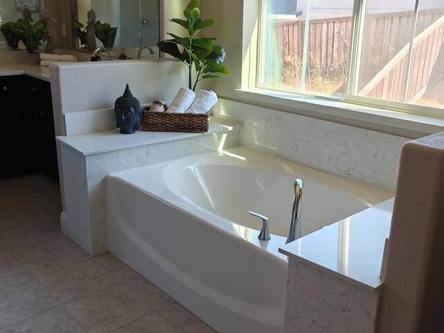 bathroom with tile patterned flooring and a bathtub