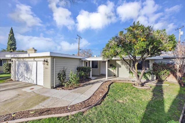 ranch-style house featuring a front yard and a garage