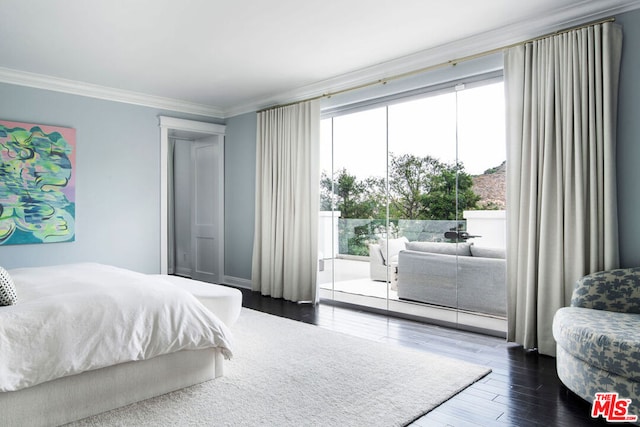 bedroom with dark hardwood / wood-style flooring and ornamental molding