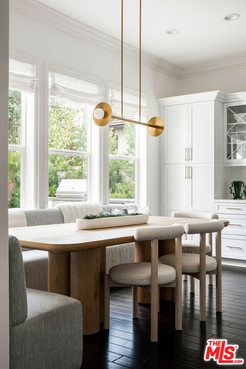 dining room with dark hardwood / wood-style floors and ornamental molding