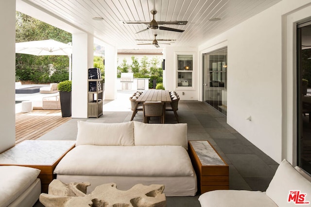 view of patio / terrace with ceiling fan and exterior kitchen