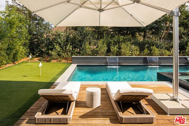 view of pool with pool water feature and a wooden deck