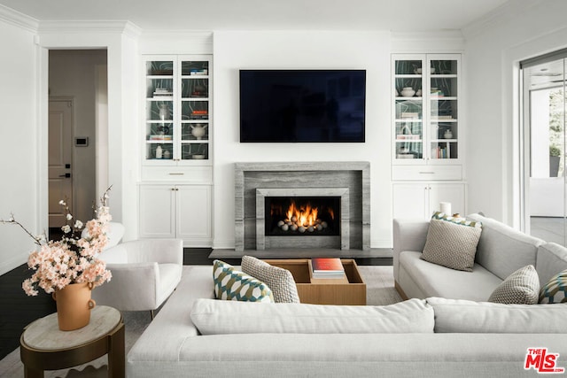 living room with ornamental molding, a fireplace, and hardwood / wood-style floors