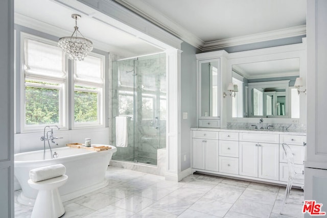 bathroom with plus walk in shower, an inviting chandelier, crown molding, and vanity