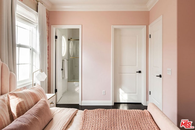 bedroom featuring dark wood-type flooring, multiple windows, crown molding, and ensuite bath