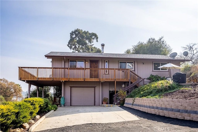 view of front of home featuring an attached garage, driveway, and stairway