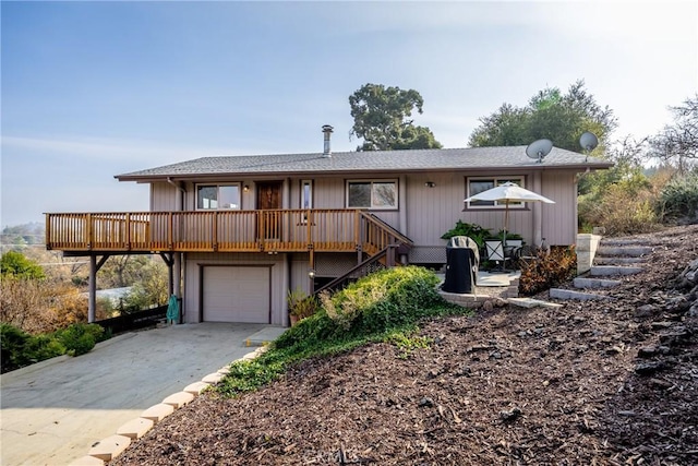 view of front facade with a deck and a garage