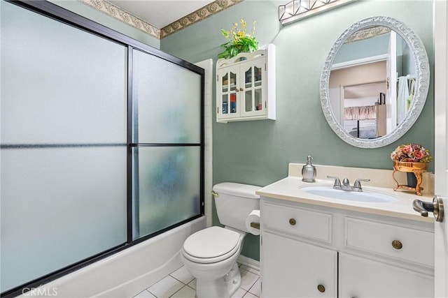 full bathroom featuring tile patterned floors, combined bath / shower with glass door, vanity, and toilet