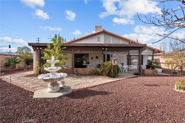 back of house with a patio