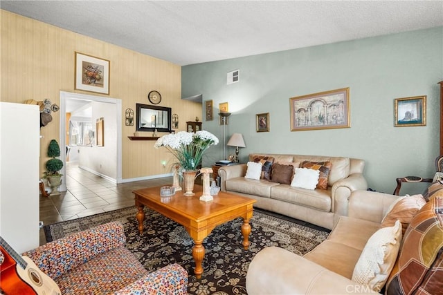 living room featuring a textured ceiling and tile patterned flooring