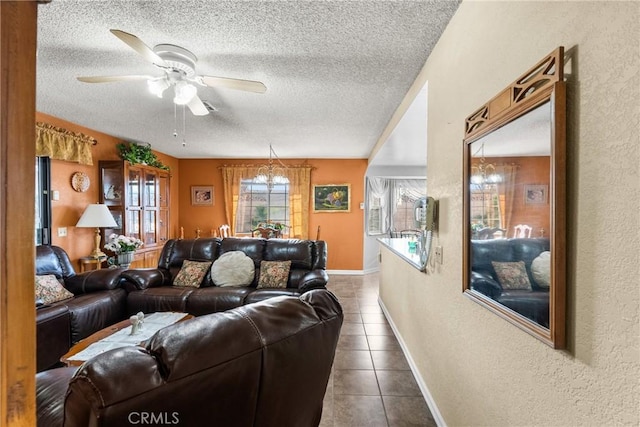 tiled living room featuring ceiling fan with notable chandelier and a textured ceiling