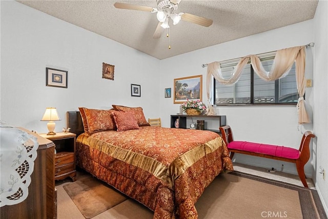 carpeted bedroom with ceiling fan and a textured ceiling