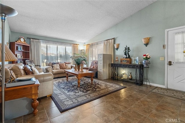 living room featuring vaulted ceiling and a textured ceiling