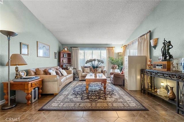 living room featuring a textured ceiling, lofted ceiling, and tile patterned floors