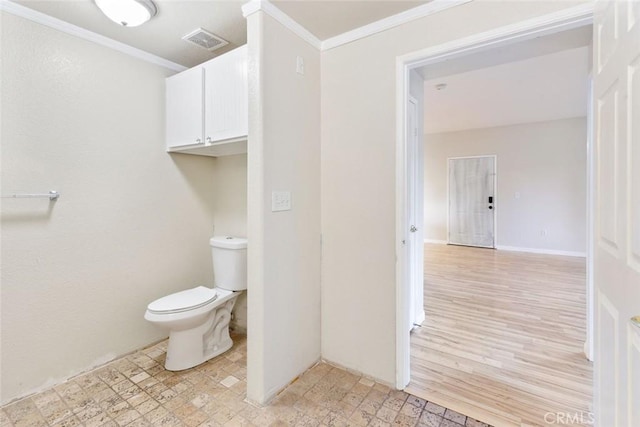 bathroom with toilet and ornamental molding