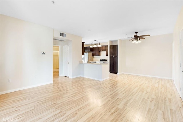 unfurnished living room with ceiling fan, sink, and light hardwood / wood-style flooring