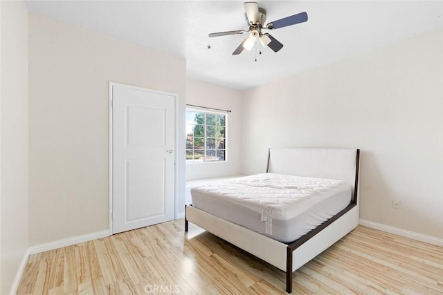 bedroom with ceiling fan and light hardwood / wood-style floors