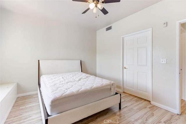 bedroom with ceiling fan and light hardwood / wood-style flooring