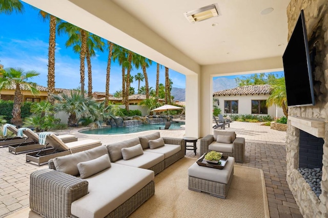 view of patio with pool water feature, a fenced in pool, and outdoor lounge area