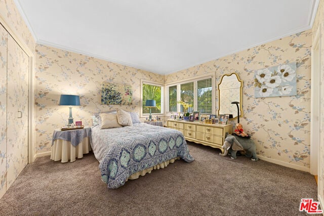 carpeted bedroom with ornamental molding