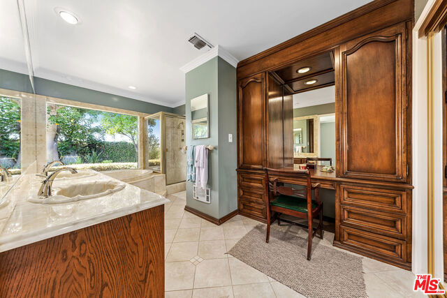 bathroom with vanity, tile patterned floors, and crown molding