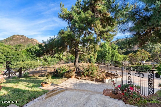 surrounding community featuring a patio area and a mountain view