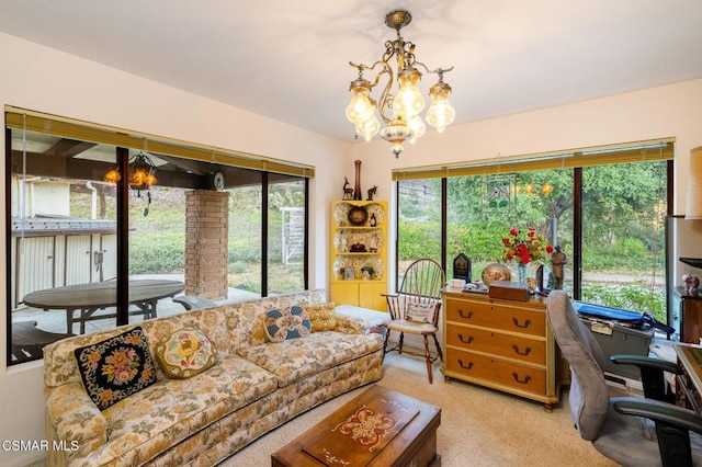 carpeted living room with plenty of natural light and a chandelier