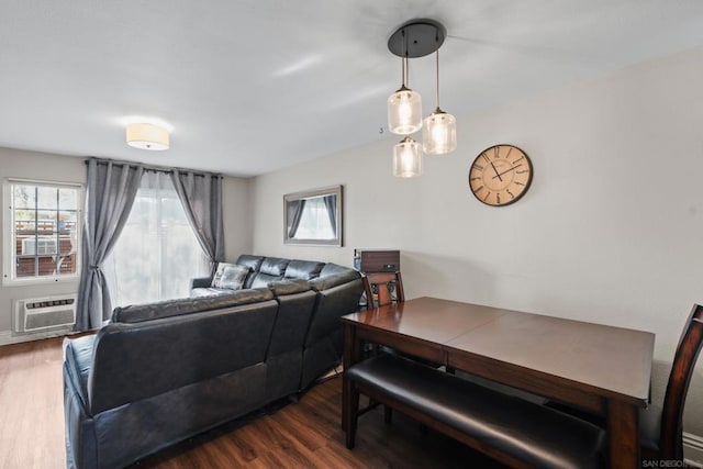 living room with a wall unit AC and dark hardwood / wood-style floors