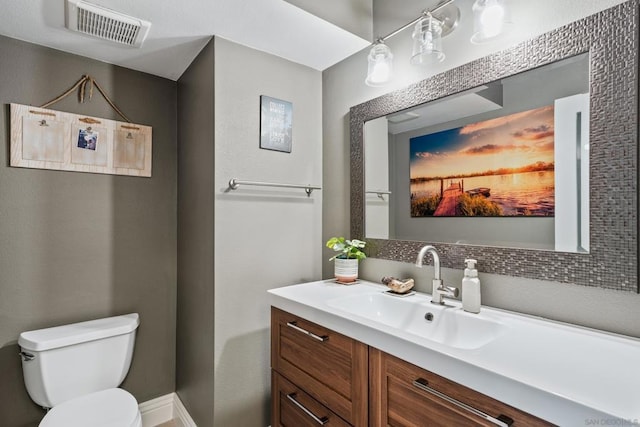 bathroom with toilet and vanity