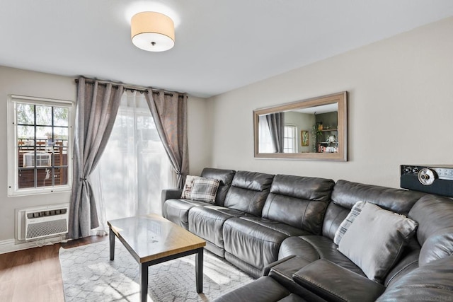 living room with hardwood / wood-style floors and a wall mounted air conditioner