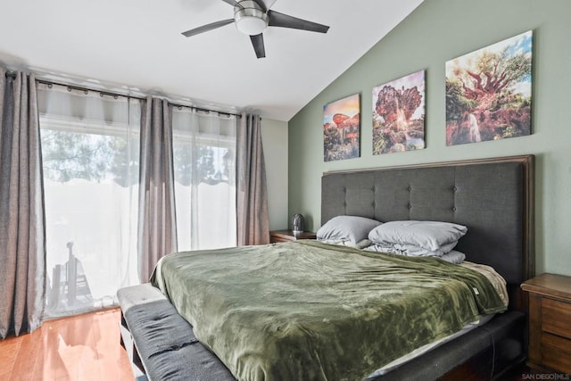 bedroom with ceiling fan, lofted ceiling, and hardwood / wood-style flooring