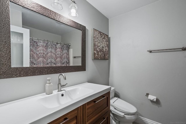 bathroom featuring toilet and vanity