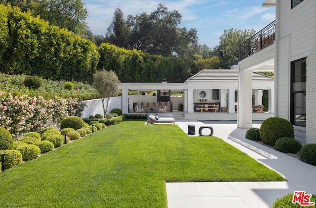 view of yard with a patio area and a balcony