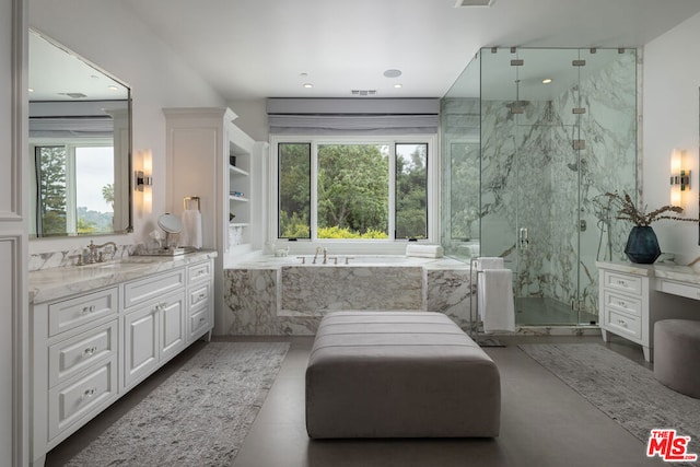 bathroom featuring built in shelves, vanity, and shower with separate bathtub