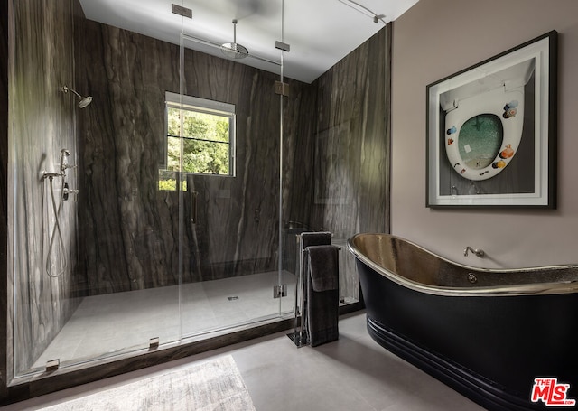 bathroom with independent shower and bath and concrete flooring