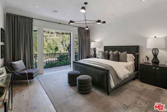 bedroom with a chandelier, crown molding, hardwood / wood-style flooring, and access to outside