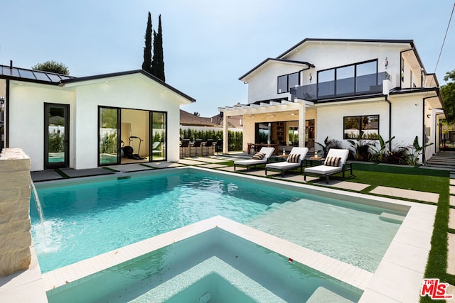 back of house featuring a patio area, a pool with hot tub, and pool water feature