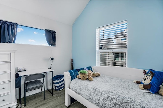 bedroom with vaulted ceiling and hardwood / wood-style flooring