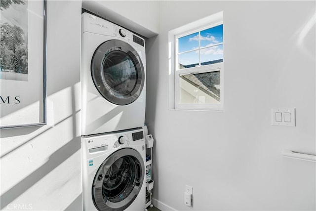 washroom with stacked washer and clothes dryer