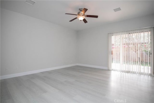 empty room with ceiling fan, light hardwood / wood-style floors, and a wealth of natural light