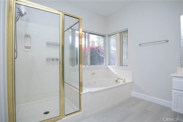 bathroom featuring separate shower and tub and wood-type flooring