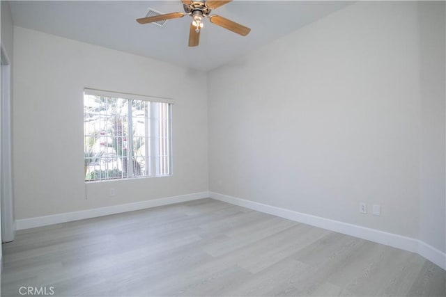 spare room featuring ceiling fan and light hardwood / wood-style flooring