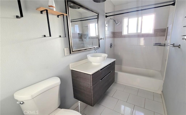 full bathroom with toilet, vanity, tile patterned flooring, and tiled shower / bath