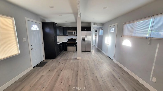 kitchen featuring light wood-type flooring and appliances with stainless steel finishes