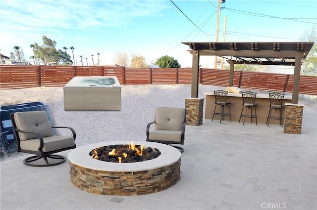 view of patio with an outdoor fire pit, a bar, and a pergola