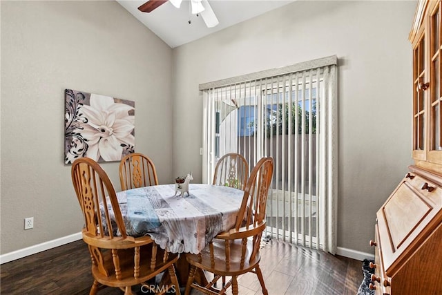 dining area with vaulted ceiling, dark wood-type flooring, and ceiling fan