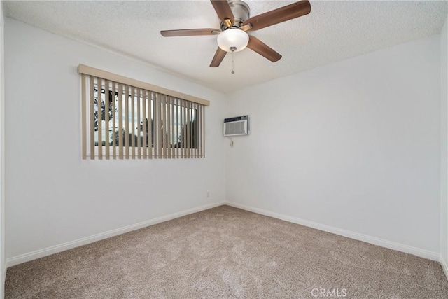 carpeted empty room with ceiling fan, a textured ceiling, and a wall mounted air conditioner