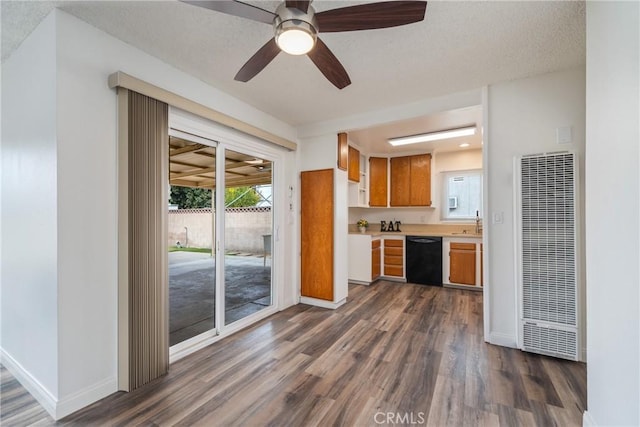 kitchen with ceiling fan, black dishwasher, and dark hardwood / wood-style floors