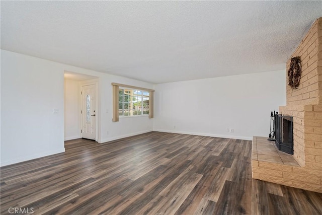 unfurnished living room with dark hardwood / wood-style floors and a textured ceiling